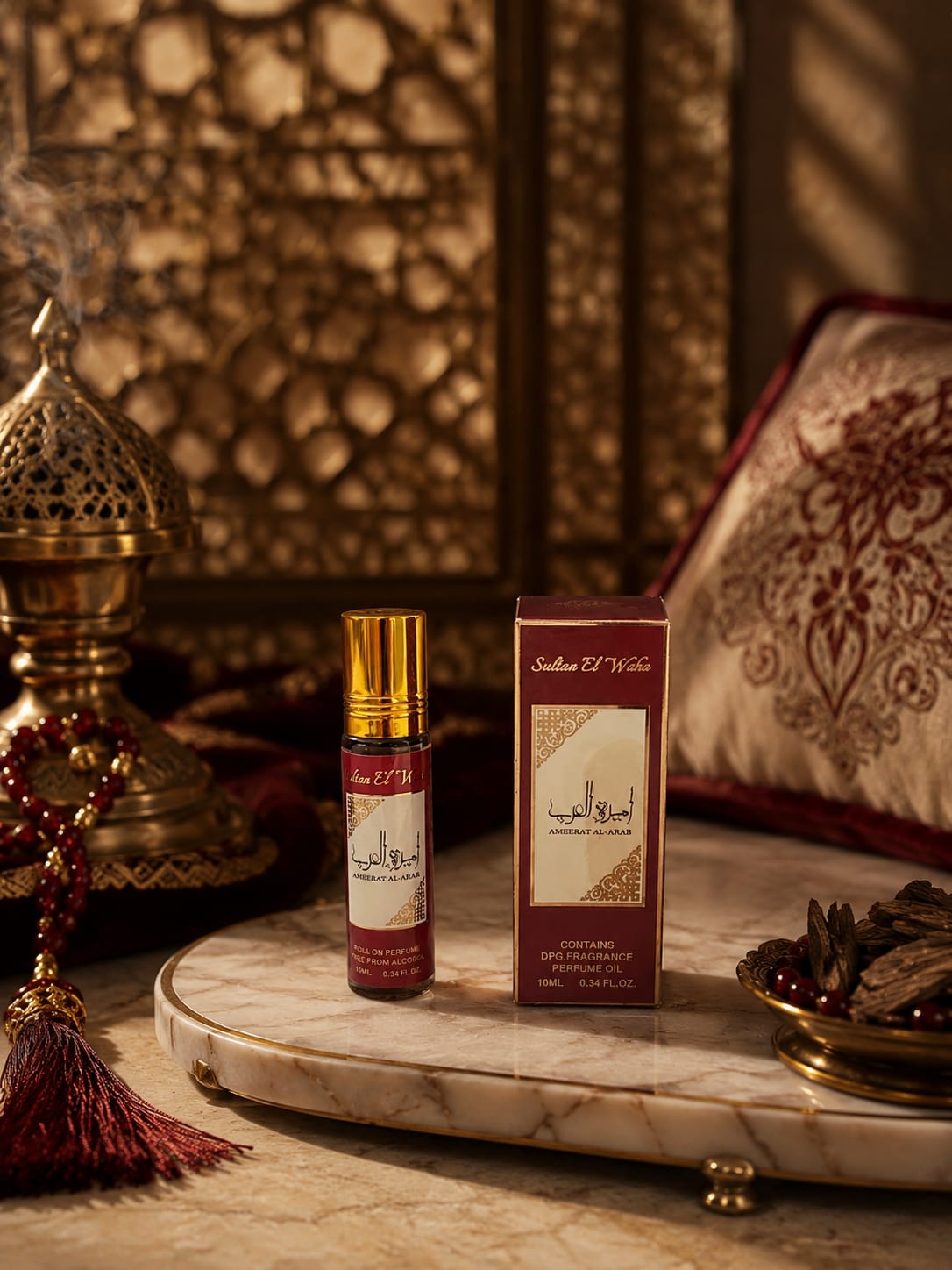 Huile de parfum concentrée Ameerat Al Arab 10 ml sans alcool Sultan El Waha, flacon roll-on bordeaux et son étui sur marbre